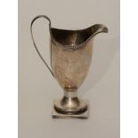 An 18th century silver cream jug, hallmarks for London 1792-93, monogrammed WMB,