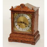 An early 20th century oak cased bracket clock, the silvered dial with Roman numerals, minute track,