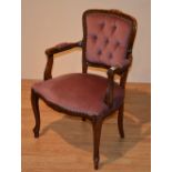 A French style open armchair, upholstered in pink velour, with buttonback and serpentine seat,