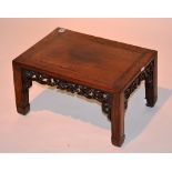 A carved Chinese Qing Dynasty Hongmu and Jichimu Kang table, with carved peaches to frieze,