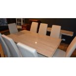 A contemporary marble and composition dining table with eight cream leather upholstered dining