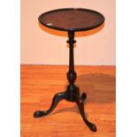 A Georgian style mahogany wine table, the circular top raised on turned column and tripod supports,