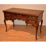 A mahogany kneehole desk, with large drawer, flanked with two short drawers,