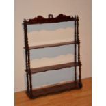 A set of mahogany four tier wall hanging shelves,