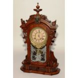 A late Victorian stained walnut American mantel clock by The Ansonia Clock Co, of large form,