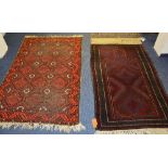 A Balouch prayer mat, the three central blue medallions over maroon ground,