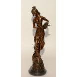 A bronze figure of a maiden collecting flowers, signed Jean Patou, on black plinth base,