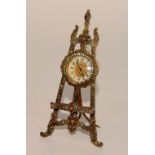 A Swiss brass and enamel desk clock in the form of a picture easel,