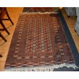 An Eastern rug, the central panel with multiple red guls on pale blue ground,