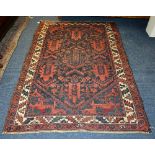 An Eastern rug, the central panel decorated with allover foliate design on navy ground,
