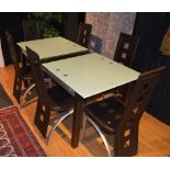 A modern glass top dining table with six brown leatherette chairs,