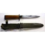 A US Marine dagger, with wooden hilt, in green sheath, stamped 'US M8A1 PWH',