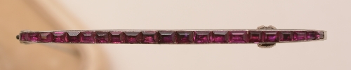 A Cartier white metal and ruby bar brooch, the 21 graduated rubies within channel setting, - Image 3 of 3