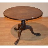 A George III mahogany snap top tripod table, the circular top,
