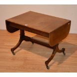 A mahogany sofa style telephone table, raised on splayed supports with brass castors,