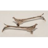 A pair of silver pheasant knife-rest holders,