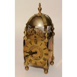 A 17th century and later brass lantern clock, the bell above chapter ring with Roman numerals,