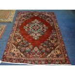 A Mahal carpet, the central floral diamond over red ground with floral surround and foliate border,