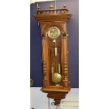 An early 20th century walnut cased Vienna three train weight driven regulator wall clock,