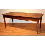 An antique pine farmhouse refectory table, old worm to underside,