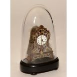 A miniature wood cased mantel clock, with foliate panels on metal mount under glass dome,