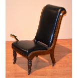 A Victorian walnut reclining chair, with brass adjustable lever, raised on turned supports,