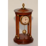 A French stained walnut four pillar mantel clock, with cast brass pineapple finial,