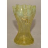 An Art Nouveau vaseline glass vase, with frilly rim over impressed stylised flowerheads,