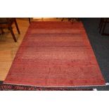 A Kashkuli rug from South Western Iran, of plain design on red ground,