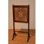 A Victorian mahogany firescreen, with central embroidered panel bearing the Dunlop family crest,