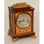 A 19th century rosewood gilt metal and ormolu mantel clock, the silvered dial with Roman numerals,