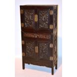 A 19th century Chinese Hongmu two section cabinet, with carved panelled doors to top and bottom,