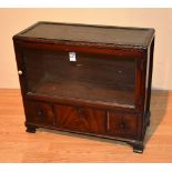 A 20th century Whytock & Reid mahogany apprentice cabinet, with glazed door above three drawers,