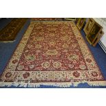 A Persian machine made carpet, with allover gold floral decoration on red ground,