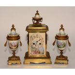 A 20th century gilt metal and porcelain three piece clock garniture signed JW Benson,
