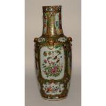 A large 19th century Canton famille rose vase, decorated with panels of figures,