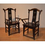 A pair of Chinese hardwood elbow chairs, with carved back panel, scroll arm rests, and solid seat,