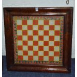 A Victorian rosewood framed chess/games panel, under glass,