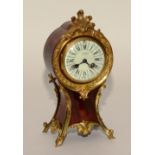 A French Louis XVI style red tortoiseshell and gilt metal mantel clock,