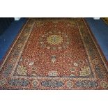 A machine made Eastern style carpet, with gold foliate medallion to centre,