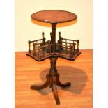A Victorian burr walnut revolving two tier book table, the circular top raised on turned stem,