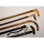 Five assorted walking sticks,