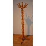 A vintage orange painted hat and coat stand, with outstretched pegs, ring turned column,