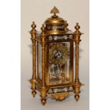 A French Louis XVI style gilt metal ormolu and champleve enamel decorated four glass mantel clock,