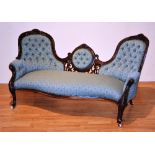 A Victorian mahogany framed settee, with trefoil back, above carved foliate fret,