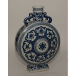 A large Chinese blue and white porcelain moon flask, decorated with floral panels,