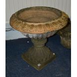 A 19th century stoneware garden urn, with lobed decoration raised on square plinth, 64cm high x 42.