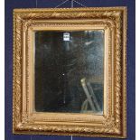 A Victorian style gilt framed wall mirror, of square form, with moulded foliate decoration,