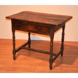 An 18th century country oak side table, the rectangular top above two drawers,
