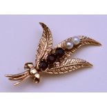 A 9ct gold garnet and seed pearl brooch,